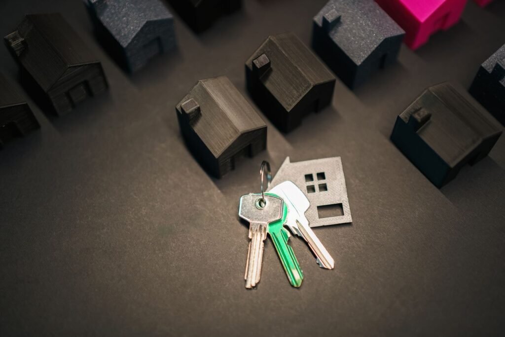 Miniature house models and keys representing rental property finances