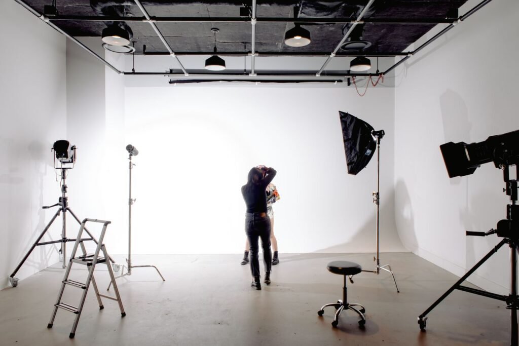 Photographer shooting a model in a modern studio, representing creative business invoicing