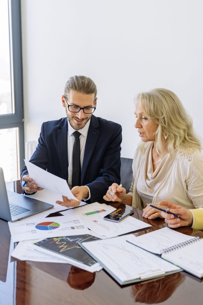 Two business professionals reviewing documents during a consulting meeting