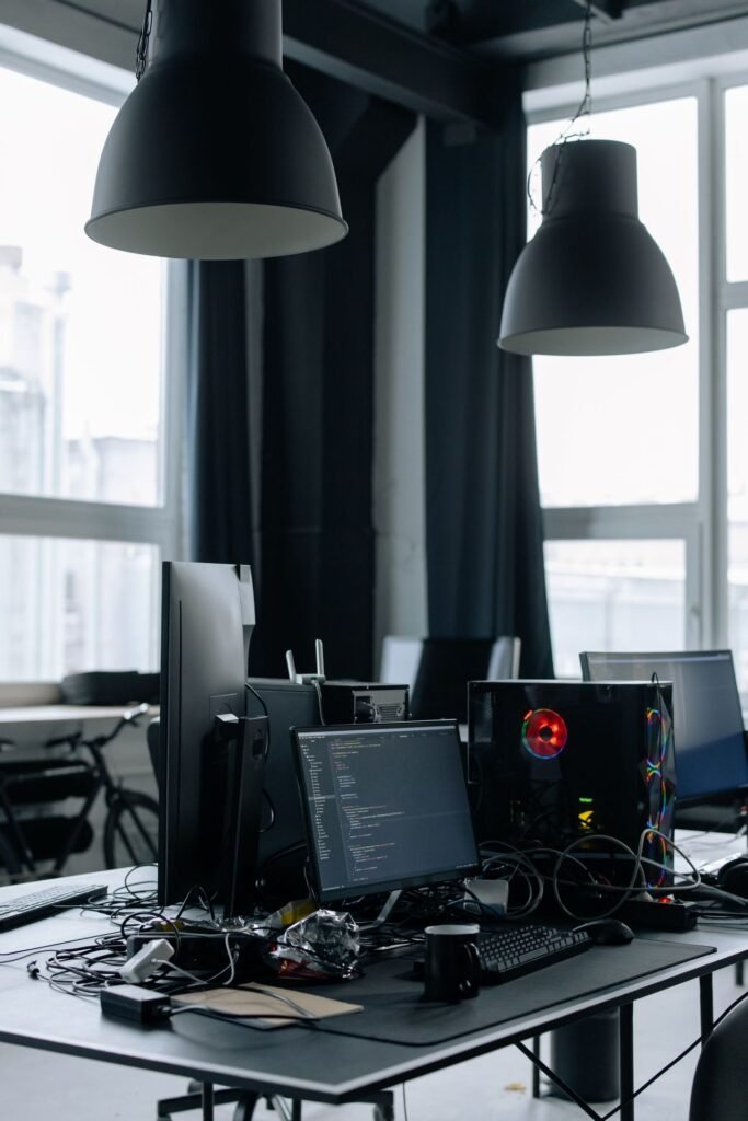 Modern office desk with desktop computers and monitors in a bright room