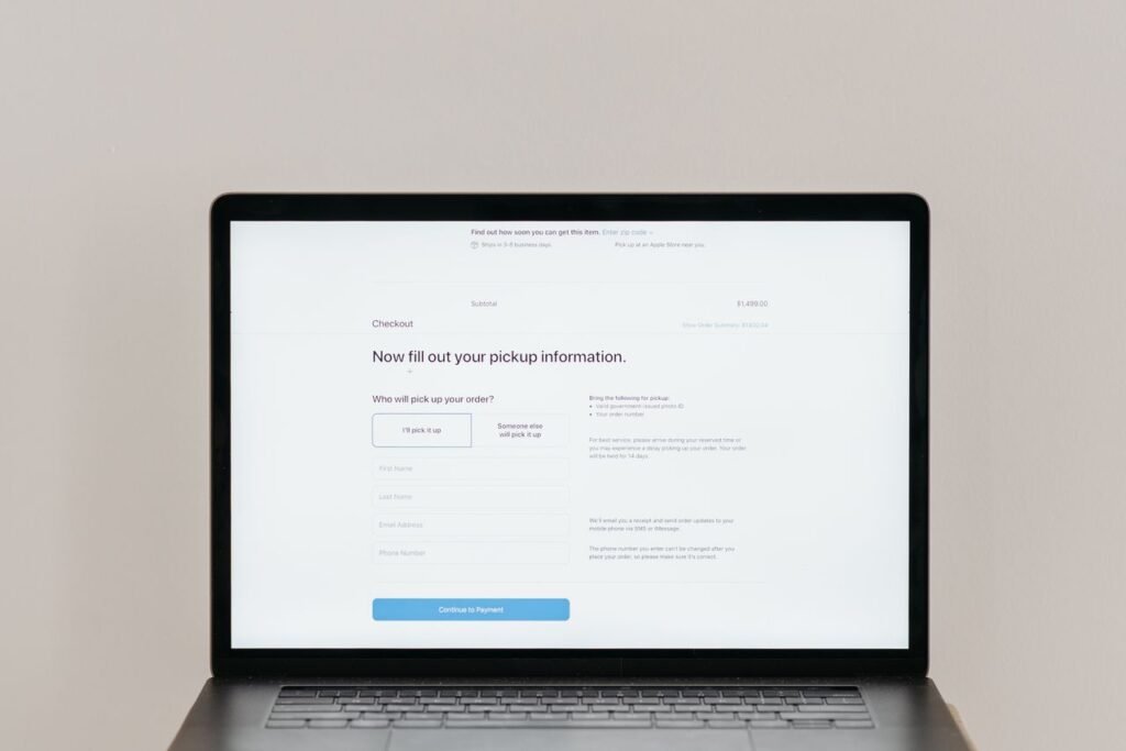 Laptop displaying an online subscription checkout and payment form