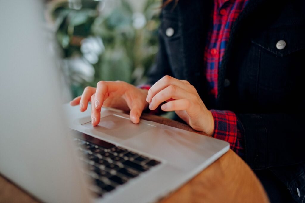 Freelancer typing on a laptop while managing business finances