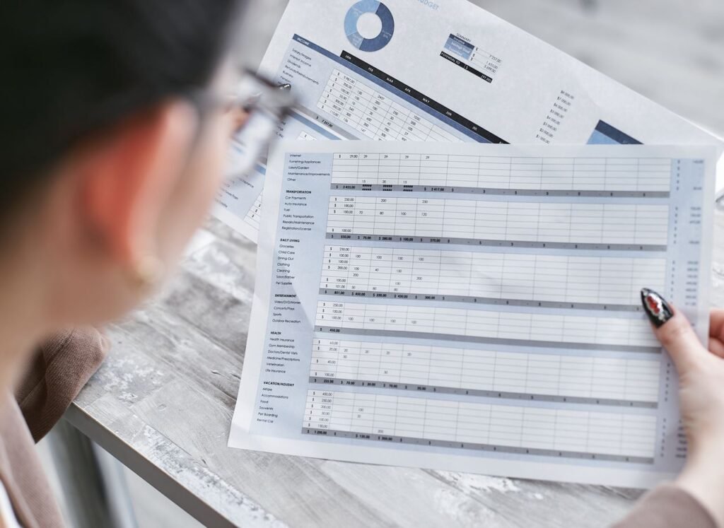 Business owner reviewing financial spreadsheets and reports during a mid-year checkup
