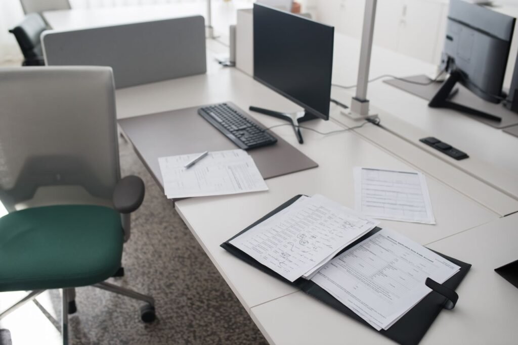 Organized office desk with documents and a computer for processing bills