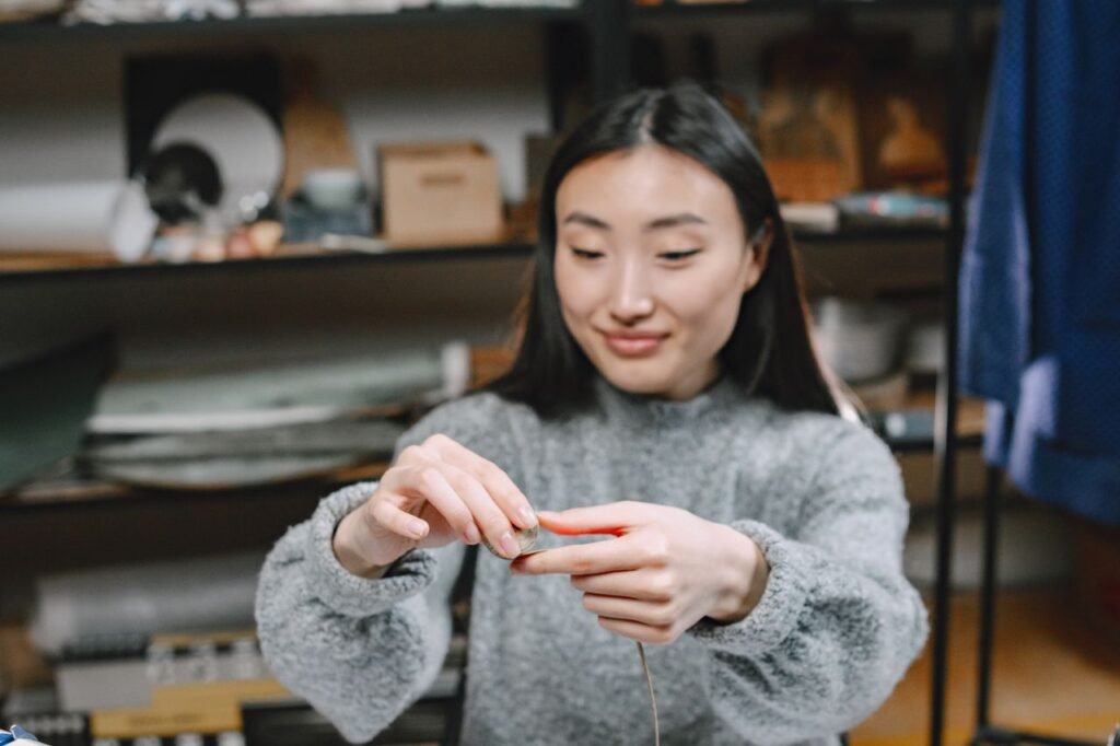 Woman sewing in a craft workshop, representing a handmade Etsy business