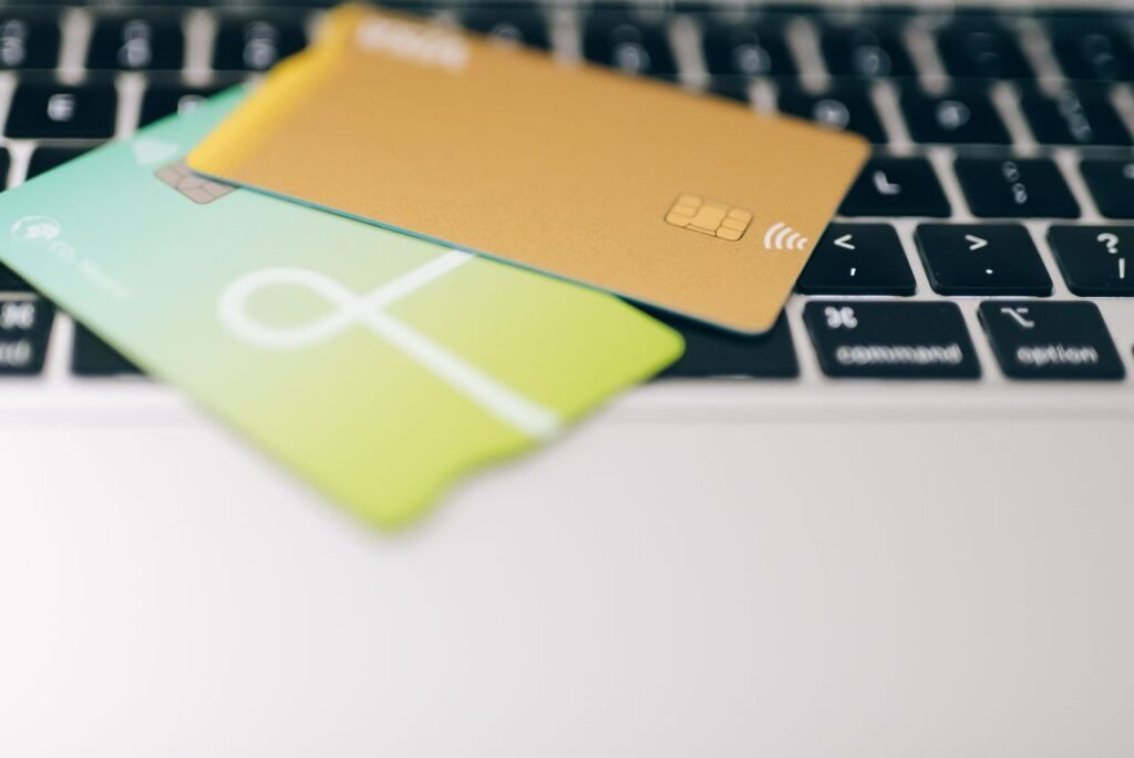 Two business bank cards resting on a laptop keyboard
